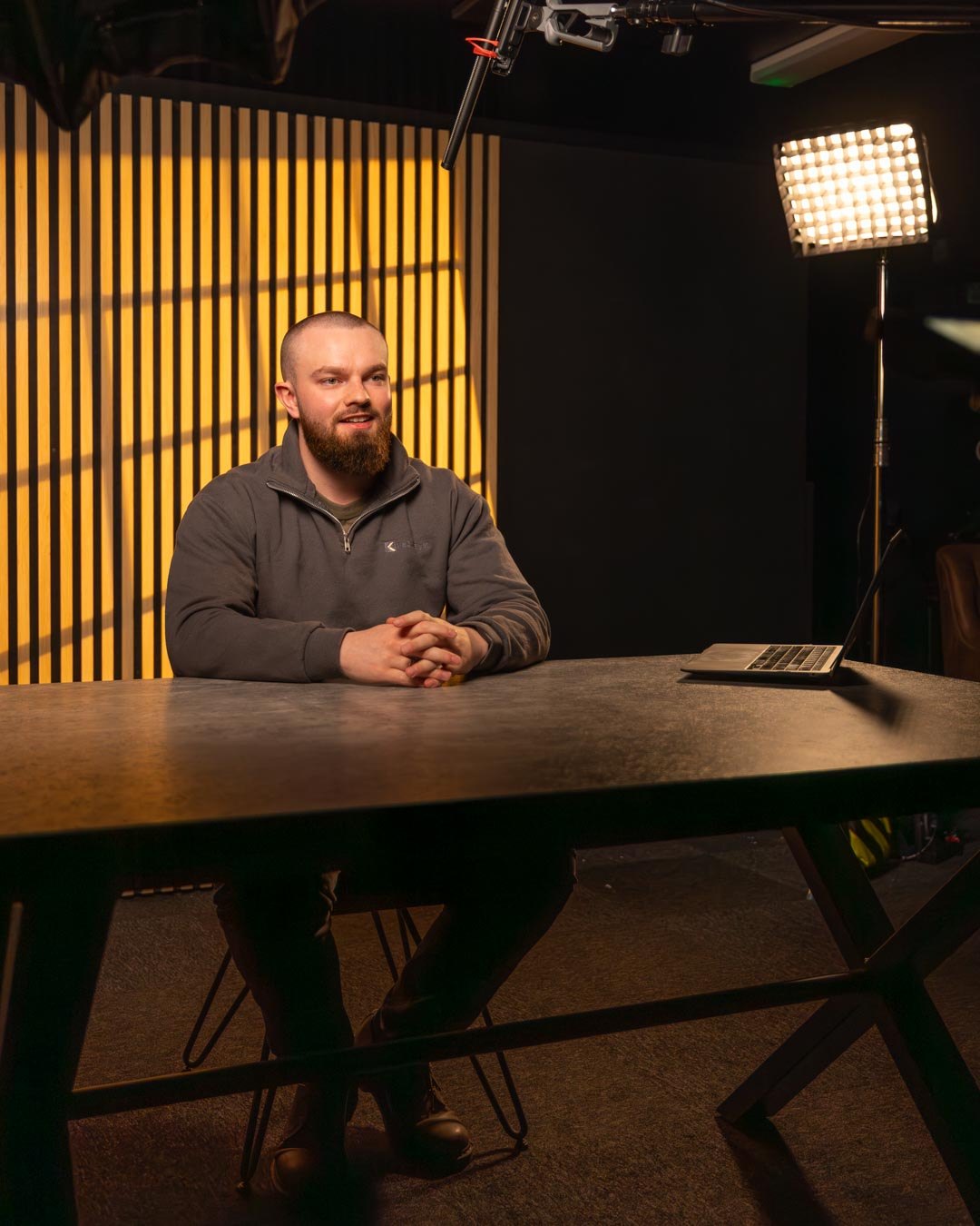 Dr Tiarnan McKeever seated at a table in the studio, mid-conversation