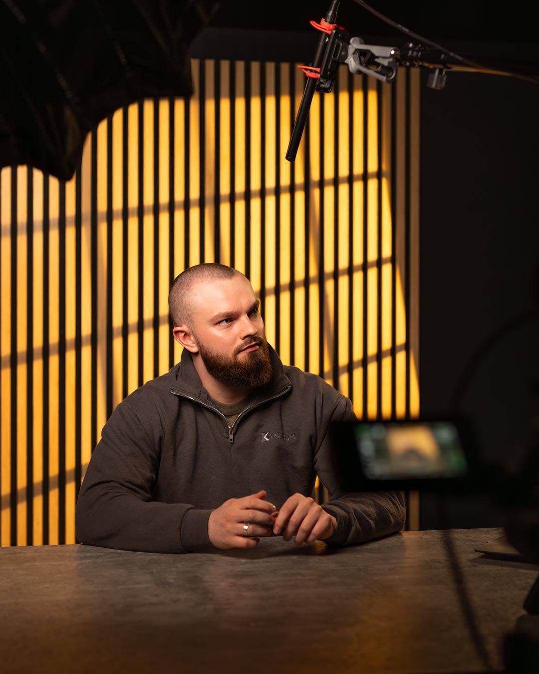 Dr Tiarnan McKeever seated at a table in a warmly lit studio