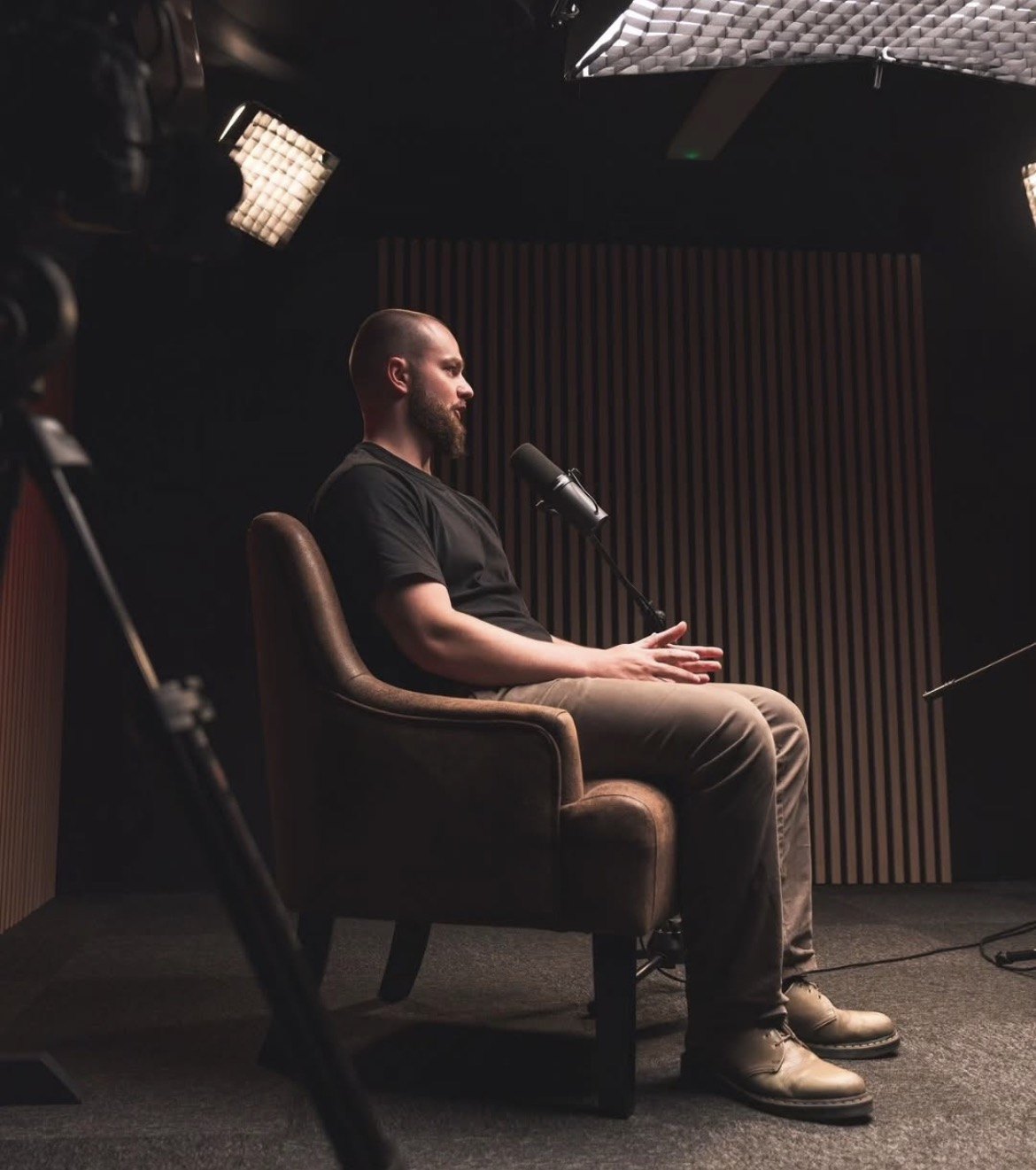 Dr Tiarnan McKeever seated beside a microphone in a studio